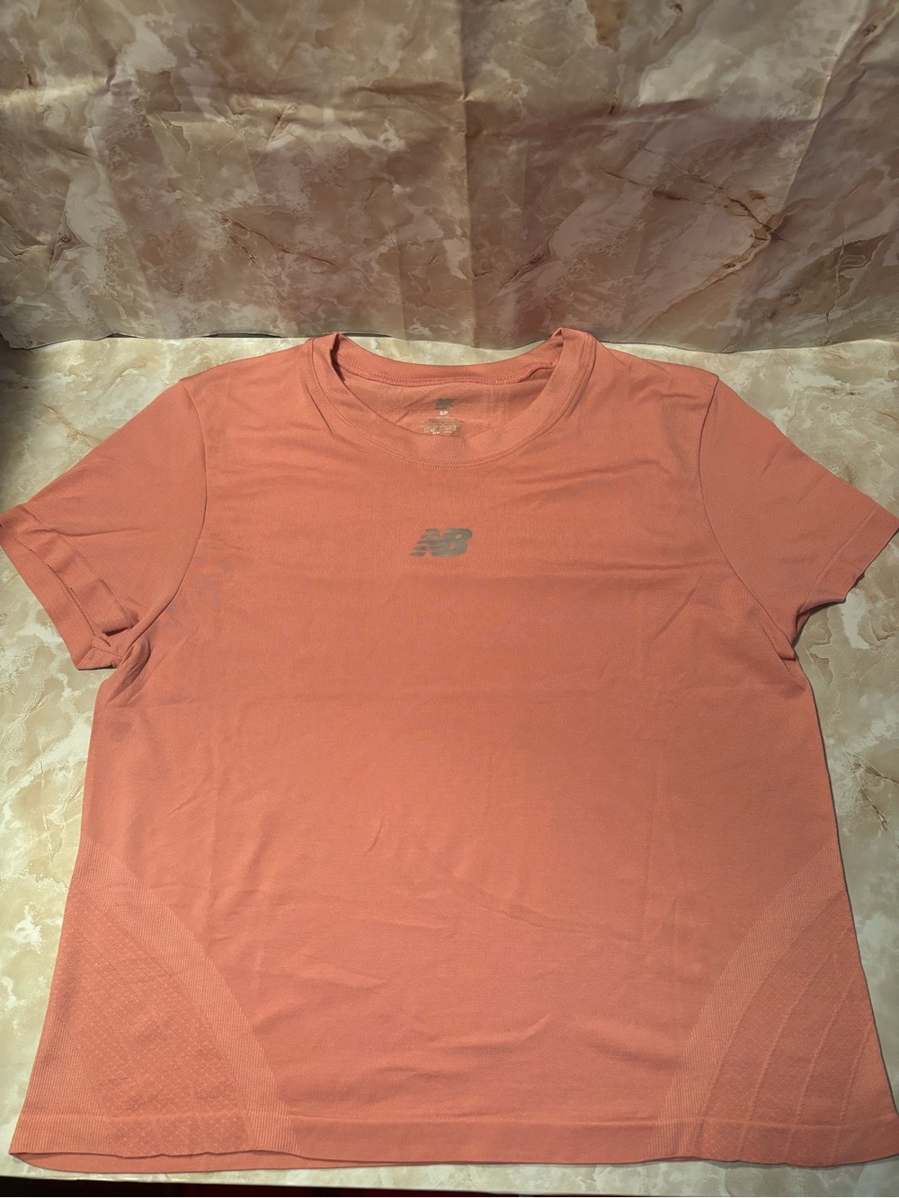 New Balance women’s Coral-Orange Performance Short Sleeve Tee